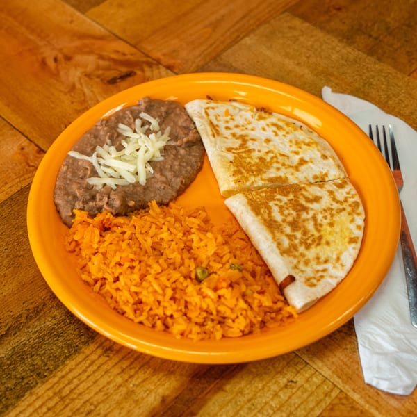 A Carnales Taqueria quesadilla meal with rice and refried beans on an orange plate.