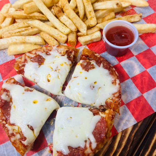 Four slices of cheesy pepperoni pizza with a side of french fries and a cup of ketchup.