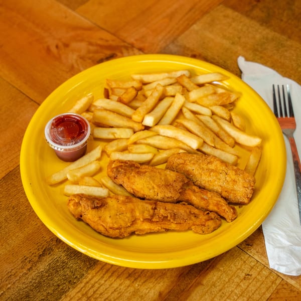 A yellow plate of crispy chicken tenders, golden french fries, and a side of ketchup.